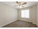 Cozy carpeted bedroom with a ceiling fan and a window providing natural light at 6591 Gertrude Ct, Las Vegas, NV 89141