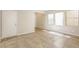 A well-lit living room featuring tiled floors, baseboards, and natural light at 6591 Gertrude Ct, Las Vegas, NV 89141