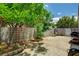 Enclosed backyard featuring a concrete patio, mature tree, and block wall at 7616 Yondering Ave, Las Vegas, NV 89131