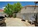 Private backyard with concrete patio, mature tree, and block wall for seclusion at 7616 Yondering Ave, Las Vegas, NV 89131
