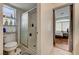 Bathroom showcasing tiled shower, and toilet, and a view to the bedroom at 7616 Yondering Ave, Las Vegas, NV 89131