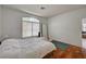 Bedroom features a large window, wood floors and a neutral color palette at 7616 Yondering Ave, Las Vegas, NV 89131