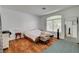 Bedroom features a large window, wood floors and a neutral color palette at 7616 Yondering Ave, Las Vegas, NV 89131