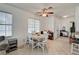 Bright dining area with a round table, white chairs, and a view of the living room, great for entertaining guests at 7616 Yondering Ave, Las Vegas, NV 89131