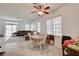 Open-concept dining area with views of the living room and backyard, featuring tile floors and natural light at 7616 Yondering Ave, Las Vegas, NV 89131