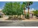 Inviting single-story home with desert landscaping, mature trees, and a two-car garage at 7616 Yondering Ave, Las Vegas, NV 89131
