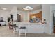 Bright kitchen with a breakfast bar, white countertops, and a view of the dining area, perfect for casual dining at 7616 Yondering Ave, Las Vegas, NV 89131