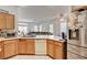 Bright eat-in kitchen featuring wood cabinets, white appliances, and an open floor plan at 7616 Yondering Ave, Las Vegas, NV 89131