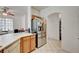 Kitchen with stainless steel refrigerator, light wood cabinets and white countertops at 7616 Yondering Ave, Las Vegas, NV 89131