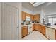 Kitchen boasts white appliances, light wood cabinets and a skylight at 7616 Yondering Ave, Las Vegas, NV 89131