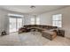Bright living room featuring a comfortable sectional sofa, tile floors, and sliding glass doors leading to outdoor space at 7616 Yondering Ave, Las Vegas, NV 89131