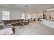 Spacious living room with neutral tile flooring, large sectional sofa, and abundant natural light, perfect for entertaining at 7616 Yondering Ave, Las Vegas, NV 89131