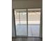 Backyard access through sliding glass doors and wood laminate floors at 8068 Cetus Cir, Las Vegas, NV 89128