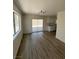 Open dining room with wood-look floors and sliding glass door to backyard at 8068 Cetus Cir, Las Vegas, NV 89128