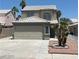 Two-story home with desert landscaping, garage, and light colored tiled roof at 8068 Cetus Cir, Las Vegas, NV 89128