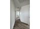 Bright hallway with wood-look floors and white walls that leads to additional rooms at 8068 Cetus Cir, Las Vegas, NV 89128