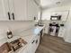 Beautiful kitchen with stainless steel appliances, white cabinets, and laminate flooring at 8068 Cetus Cir, Las Vegas, NV 89128