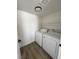 Cozy laundry room features a washer, dryer, and shelving for storage at 8068 Cetus Cir, Las Vegas, NV 89128