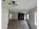 Open living room with wood-look floors, modern lighting and fireplace accent wall at 8068 Cetus Cir, Las Vegas, NV 89128