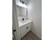 Stylish powder room showcasing a modern vanity with white countertop and black hardware at 8068 Cetus Cir, Las Vegas, NV 89128