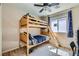 A cozy bedroom featuring a bunk bed and window with natural lighting at 8295 Nebula Cloud Ave, Las Vegas, NV 89131