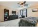 Spacious bedroom with dark wood furniture and a ceiling fan, perfect for relaxation and restful nights at 8295 Nebula Cloud Ave, Las Vegas, NV 89131