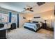Comfortable bedroom with a ceiling fan, neutral tones, and ample natural light from the large window at 8295 Nebula Cloud Ave, Las Vegas, NV 89131