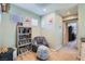Reading nook or study area with comfortable chair and a bookcase at 8295 Nebula Cloud Ave, Las Vegas, NV 89131