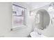Cozy bathroom featuring a classic pedestal sink, large mirror, and updated lighting at 8341 Lower Trailhead Ave, Las Vegas, NV 89113