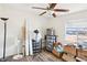 Light-filled bedroom with wood-look floors, a ceiling fan, and a street view from the window at 8341 Lower Trailhead Ave, Las Vegas, NV 89113