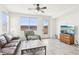 Bright living room featuring tile floors, large windows, and cozy seating arrangements at 8341 Lower Trailhead Ave, Las Vegas, NV 89113