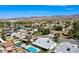 Suburban aerial shot showcasing the neighborhood's swimming pools, verdant trees, and sweeping mountain vistas at 836 Cherry Dr, Henderson, NV 89002