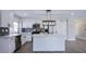 Modern kitchen featuring white cabinets, an island, stainless steel appliances, and a stylish backsplash at 836 Cherry Dr, Henderson, NV 89002