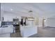 Bright kitchen features white cabinets, an island with a quartz countertop, and stainless-steel appliances at 836 Cherry Dr, Henderson, NV 89002