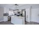 Well-designed kitchen with white cabinets, quartz countertops, an island, and modern lighting fixtures at 836 Cherry Dr, Henderson, NV 89002