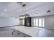 Open-concept living room features a fireplace, French doors, an island, and modern lighting at 836 Cherry Dr, Henderson, NV 89002