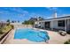 Beautiful pool with attached jacuzzi next to covered patio and bench seating at 836 Cherry Dr, Henderson, NV 89002