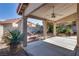 Covered back patio featuring pillars, plants, and fan at 8771 Martinique Bay Ln, Las Vegas, NV 89147