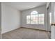 Bright carpeted bedroom features large window and closet at 8771 Martinique Bay Ln, Las Vegas, NV 89147