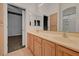 Bathroom with double vanity, a large mirror, tile floor and view to another room at 905 Star Pine Dr, Las Vegas, NV 89144