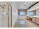 Large bathroom featuring double sinks, a glass-enclosed shower, and tile floors at 905 Star Pine Dr, Las Vegas, NV 89144