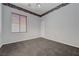 A clean, carpeted bedroom with a window bringing in natural light at 905 Star Pine Dr, Las Vegas, NV 89144