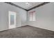 Bedroom with open door, neutral carpet and a bright window at 905 Star Pine Dr, Las Vegas, NV 89144