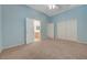 A large light blue bedroom with carpet, ceiling fan and a view to the ensuite at 905 Star Pine Dr, Las Vegas, NV 89144