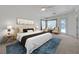 Well-lit primary bedroom with a view to the pool, a sitting area, and a neutral color palette at 905 Star Pine Dr, Las Vegas, NV 89144