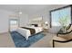 Well-lit primary bedroom with a sitting area, a view to the bath, and a neutral color palette at 905 Star Pine Dr, Las Vegas, NV 89144