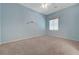 A bedroom with carpet, a window, ceiling fan, and light blue walls at 905 Star Pine Dr, Las Vegas, NV 89144