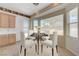 Bright dining area with a glass table set, natural light, and backyard views at 905 Star Pine Dr, Las Vegas, NV 89144