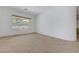 Empty room filled with abundant natural light from a large window, featuring neutral tile floors at 905 Star Pine Dr, Las Vegas, NV 89144