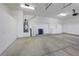 Spacious garage featuring white walls, epoxy flooring and ample storage at 905 Star Pine Dr, Las Vegas, NV 89144